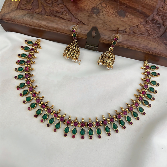 Jewelry set with necklace and earrings on a white fabric background